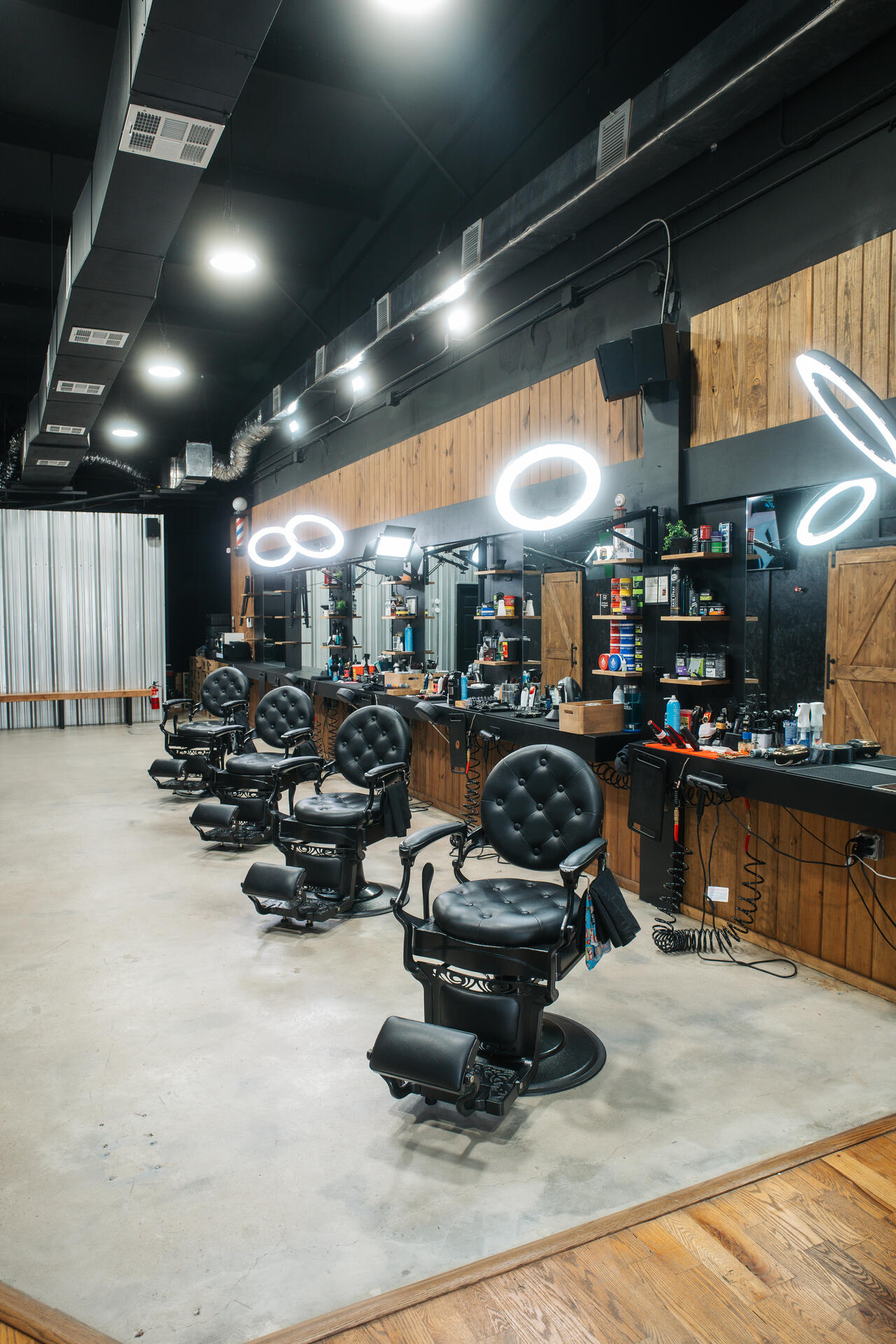 Capitano Barbershop interior with premium leather chairs and wood accents